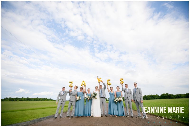 white barn, blue doors, wedding party, bride, groom, bridesmaids, groomsmen, blue bridesmaids dresses, Kennedy Blue bridesmaids, gray suits, Bloom Lake Barn, summer wedding, barn wedding, Minnesota barn wedding, blue wedding, rustic wedding, Minnesota wedding barns, Jeannine Marie Photography, Minnesota wedding photographer, Minneapolis wedding photographer, photographers near me, Saint Paul wedding photographer, wedding photography, barn wedding photographer, Bloom Lake Barn wedding photographer, Minneapolis wedding photography, Minnesota wedding photography, Studio B Floral, Unique Dining Catering, Bread Art, 139 Hair by Heidi, Laura Westrem Artistry, Che Bella Boutique, Kennedy Blue, Kohl's, Rustic Elegance, Ultimate Events, Minneapolis wedding vendors, Minnesota wedding vendors, Twin Cities wedding vendors